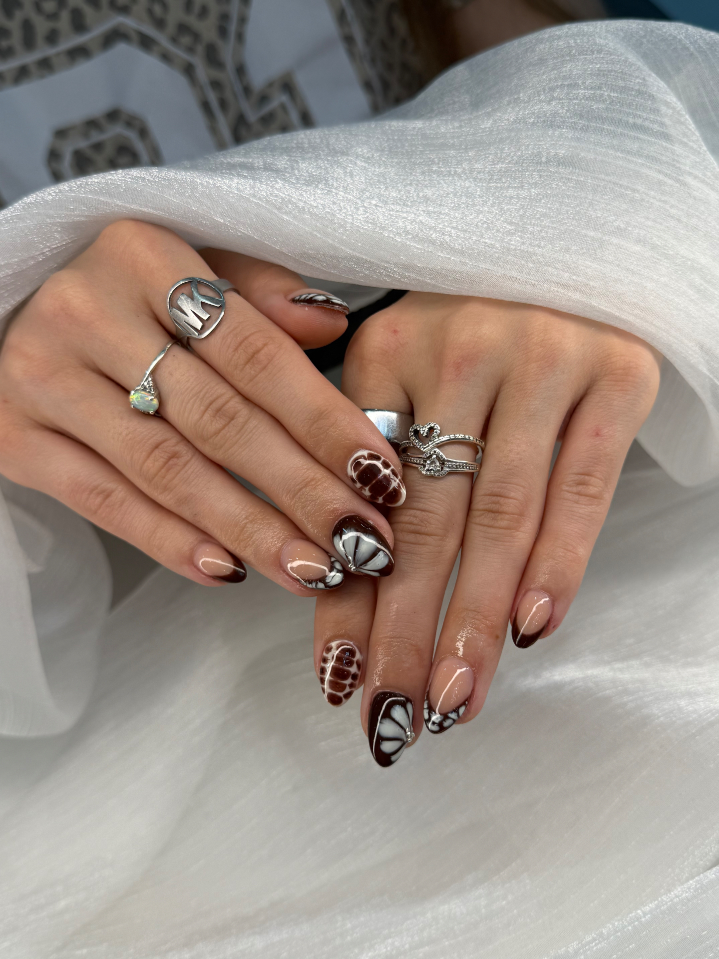 Chocolate french almond nails with tortoise and bow accents
