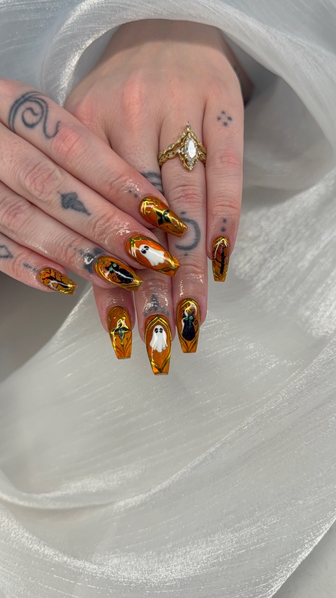 Amber chrome Halloween nails with hand-painted ghosts and cats